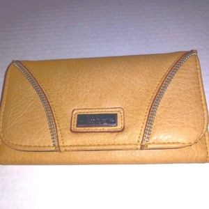 Nicole Miller fold wallet with zipper accent.
